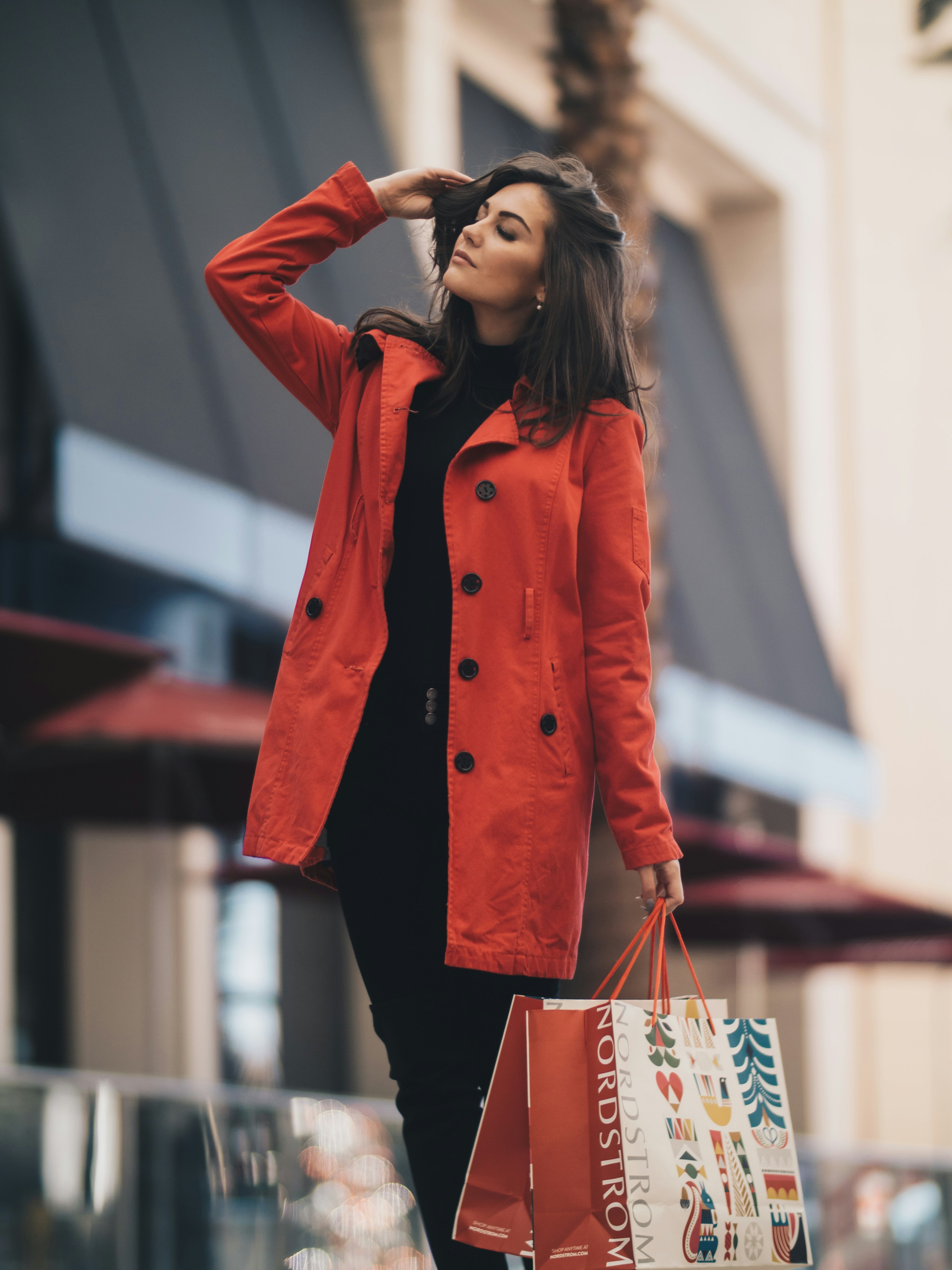 woman holding a paper bag walking on street